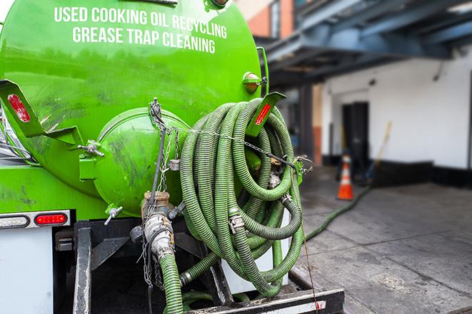 a professional service truck pumping a grease trap in Alton IL